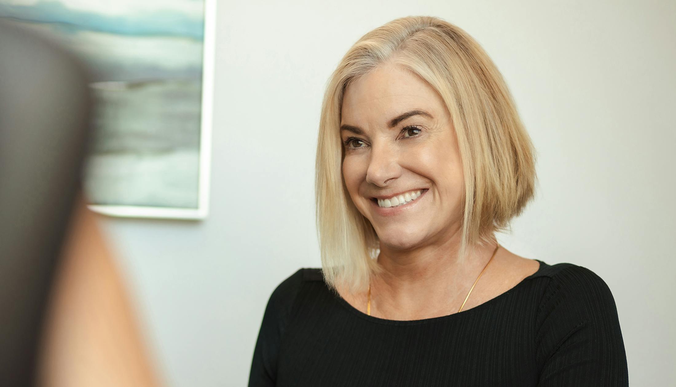 woman with short blonde hair smiling