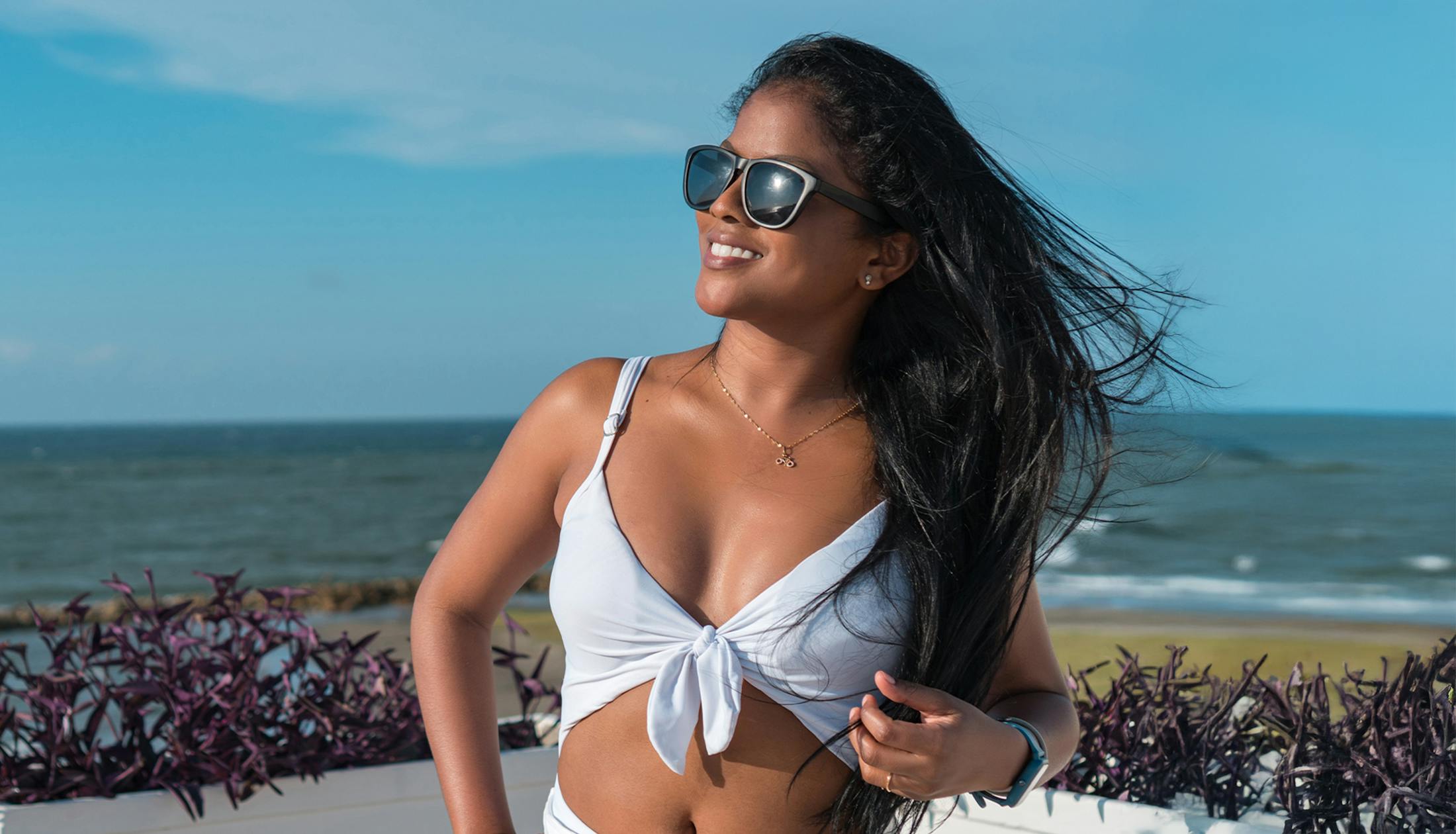 woman in white swimsuit wearing sunglasses