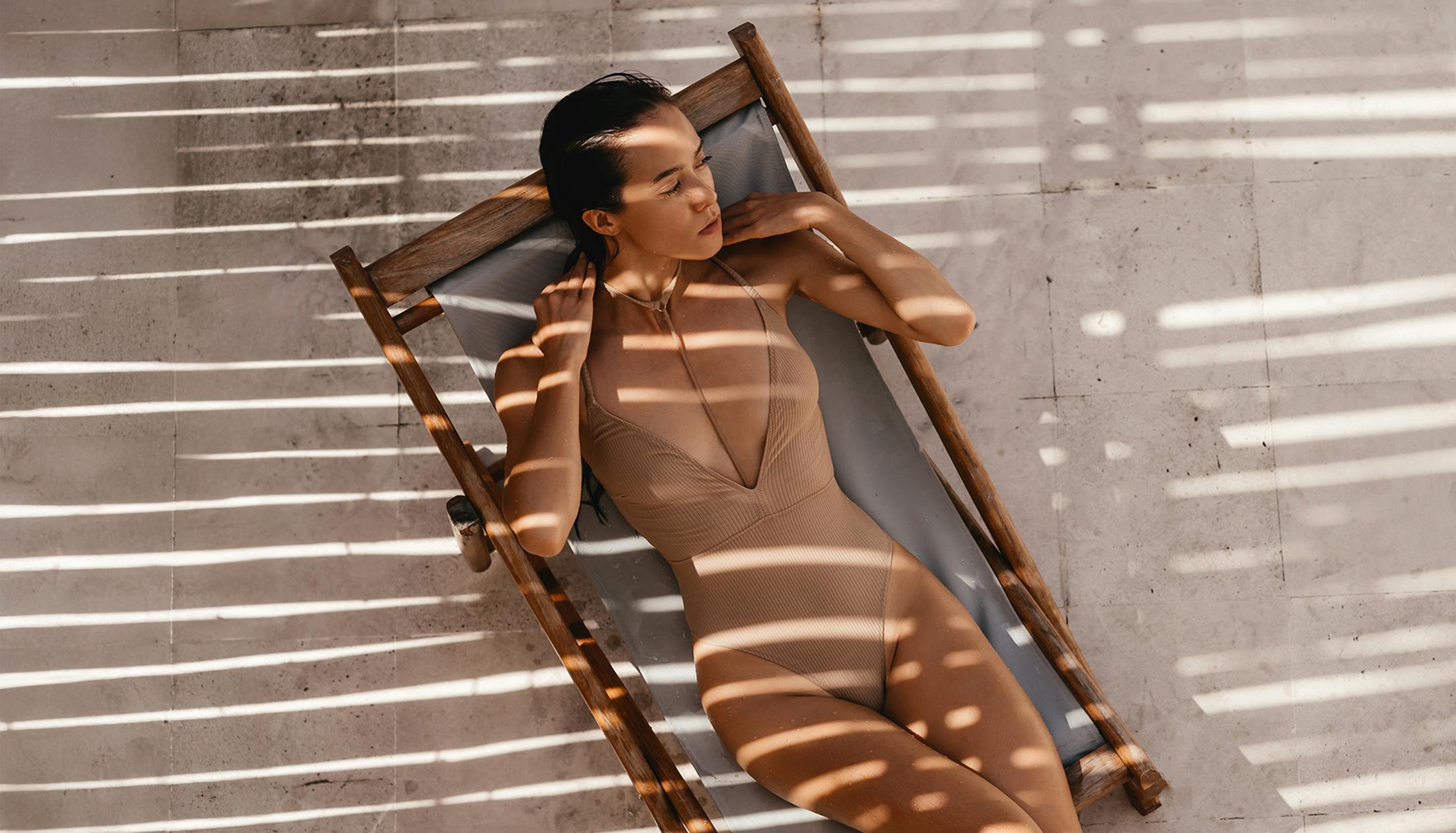woman on beach chair in swimsuit