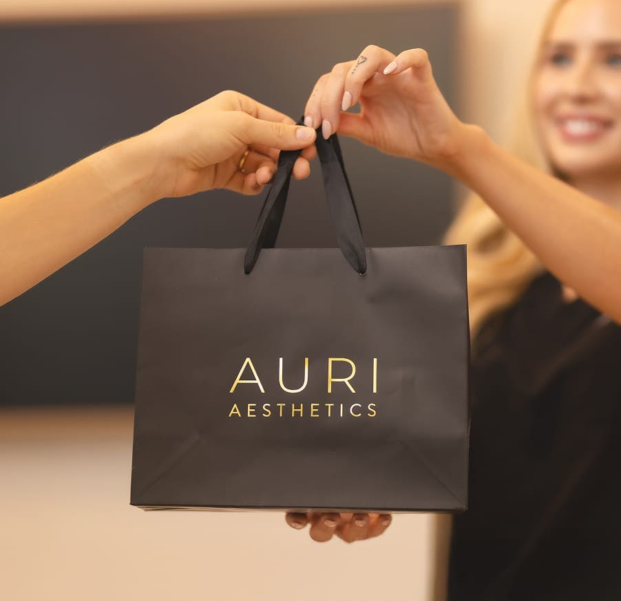 bag holding products from Auri Aesthetics