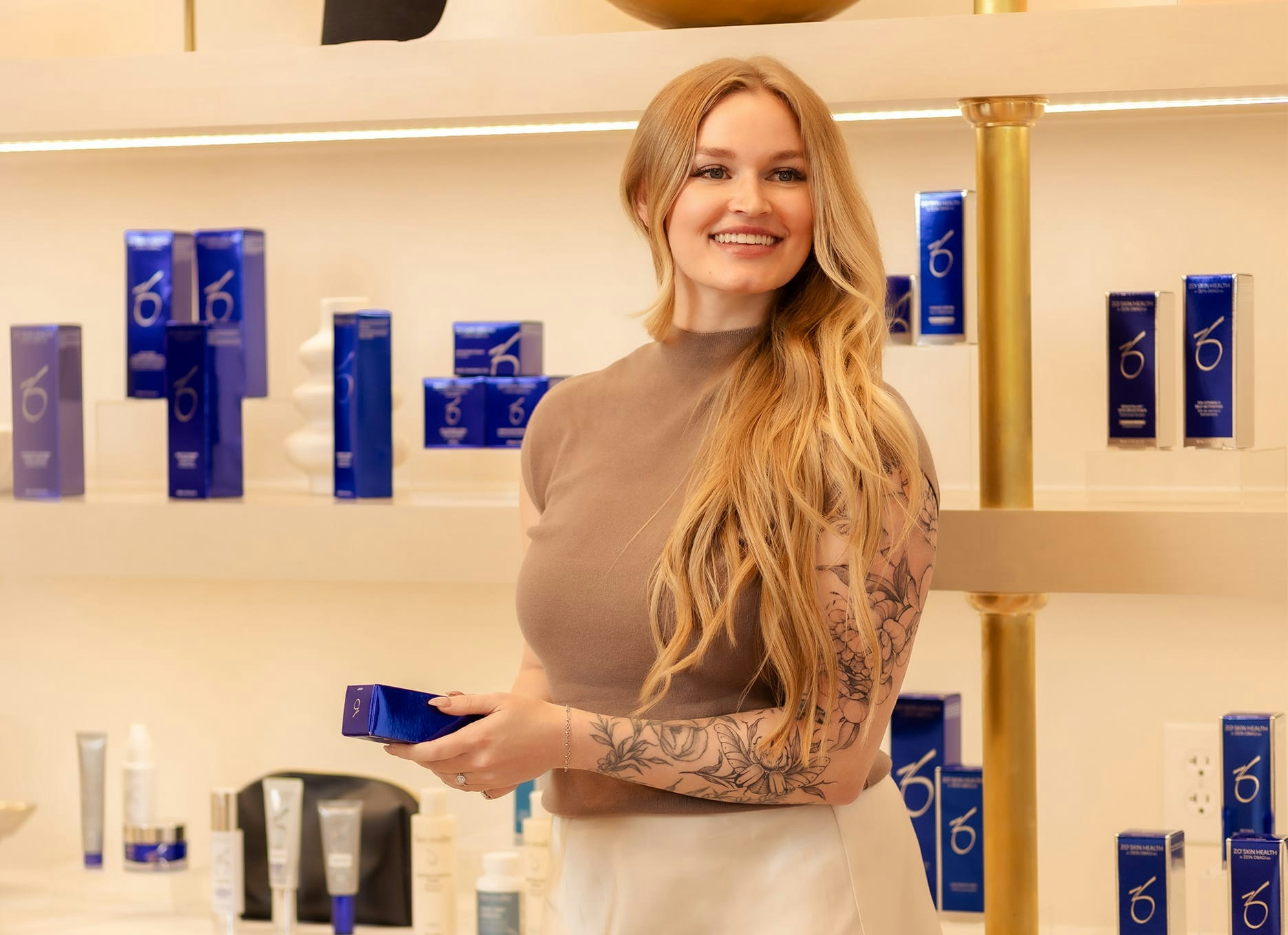 woman smiling, holding a product