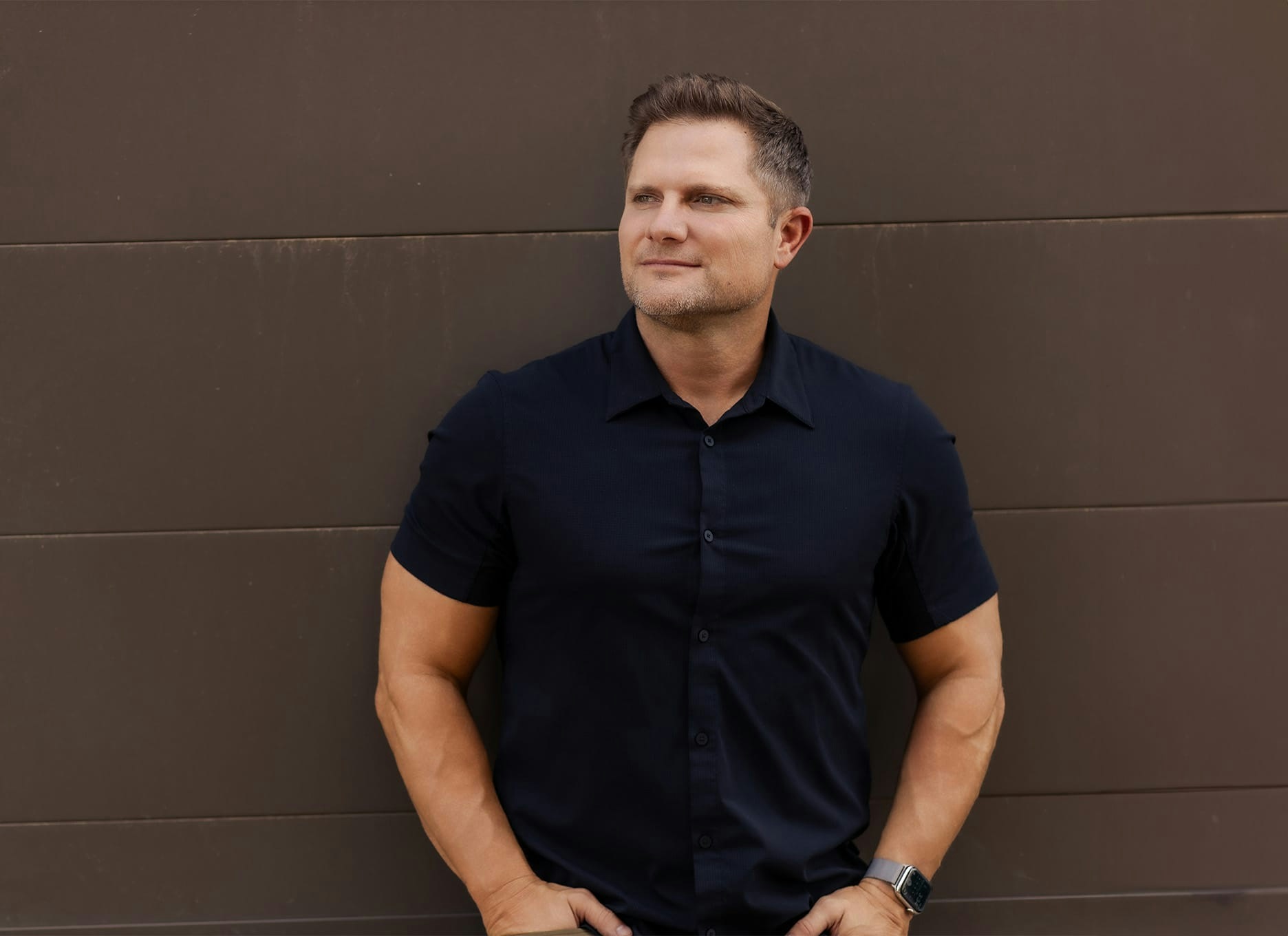 man leaning against a wall