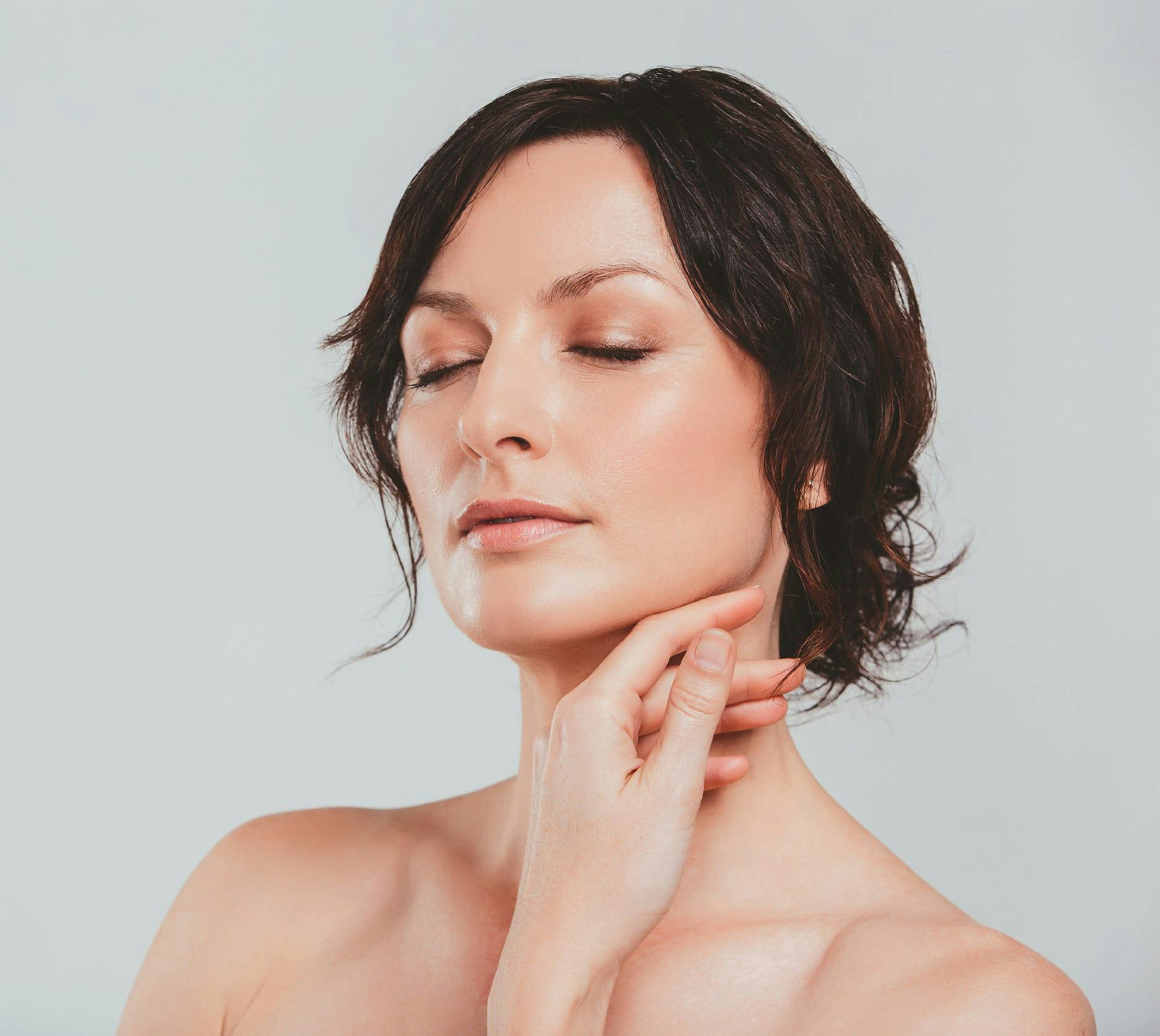 woman touching her neck