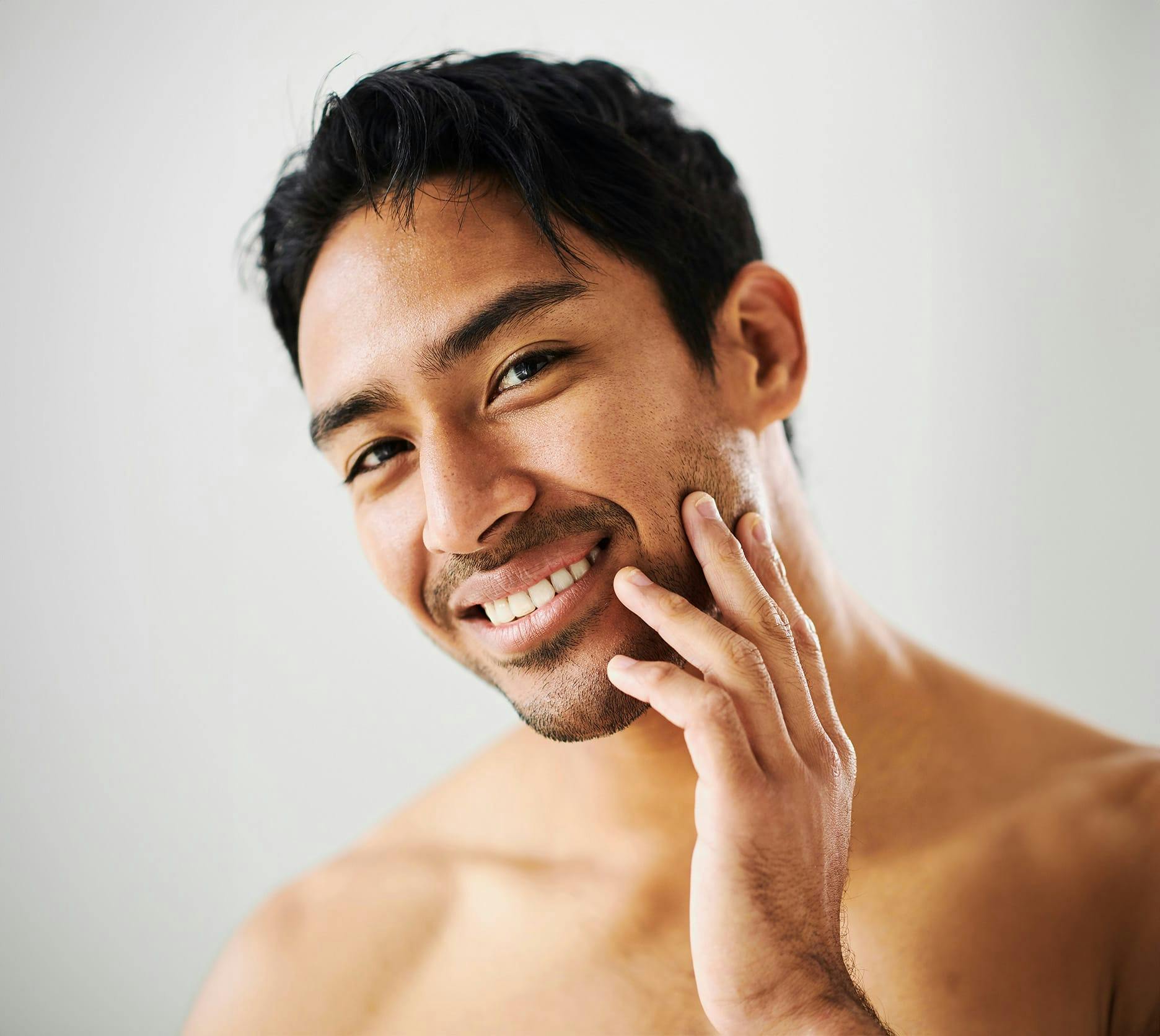 man touching his face