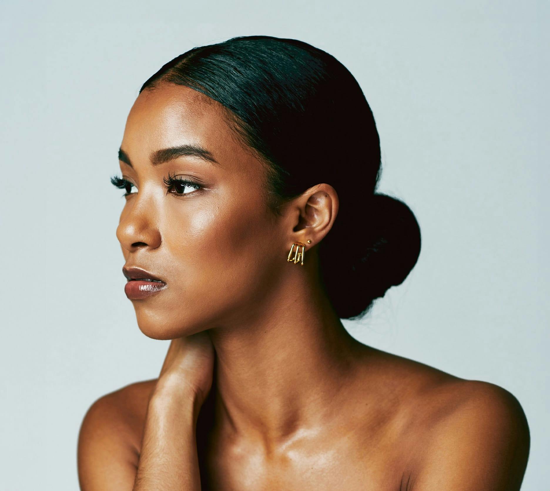 woman touching her neck