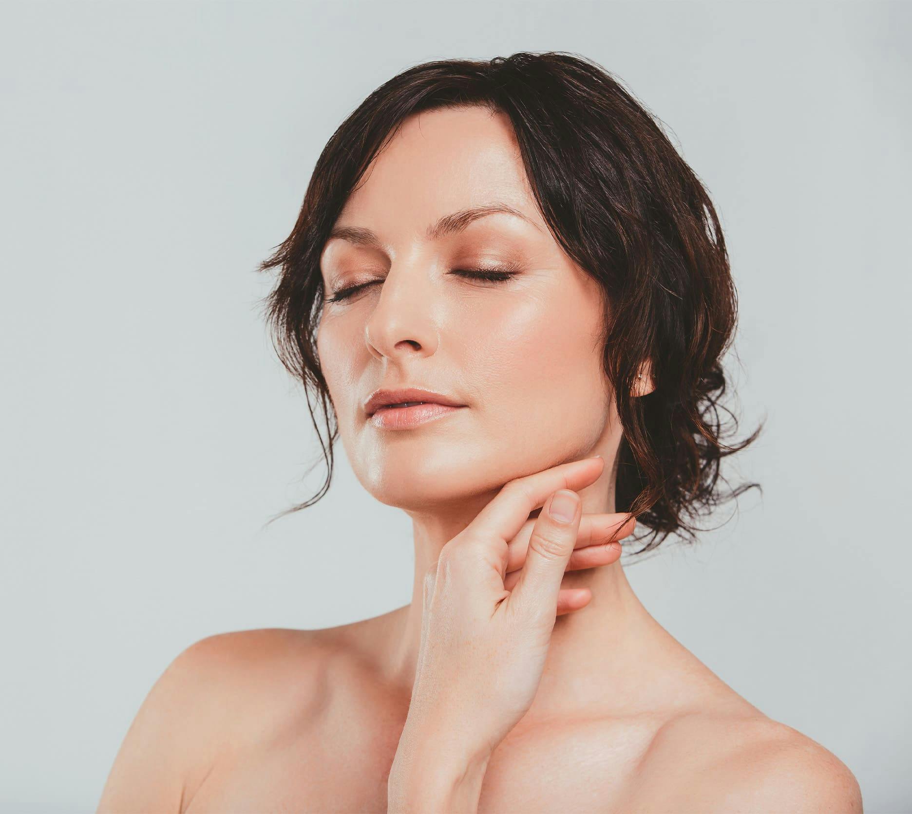 woman touching her neck