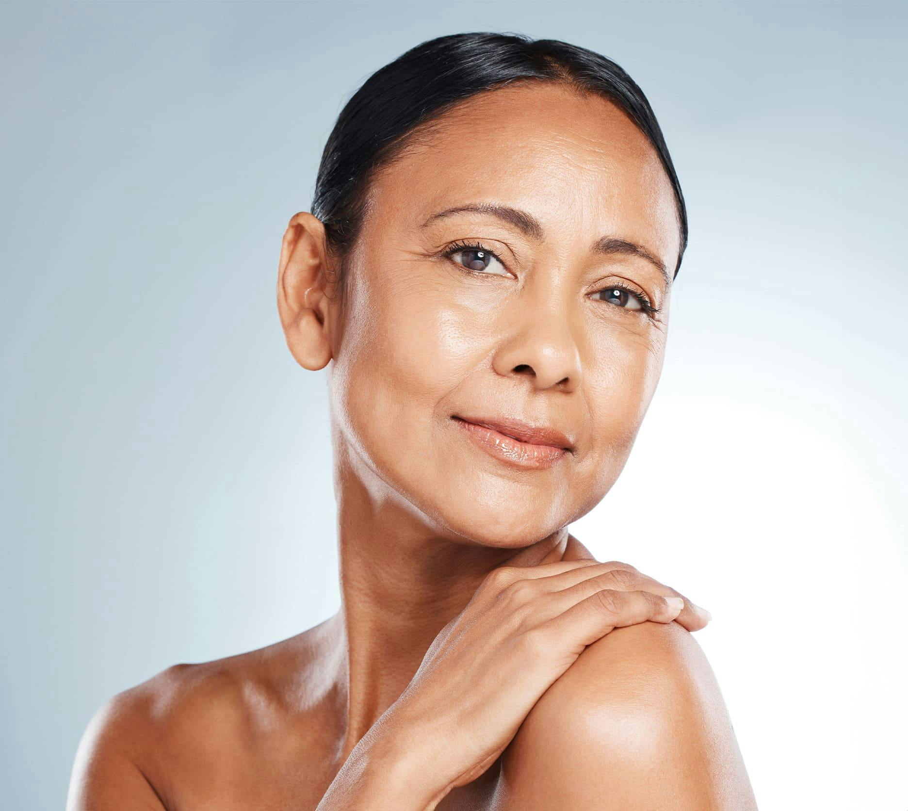 woman touching her shoulder