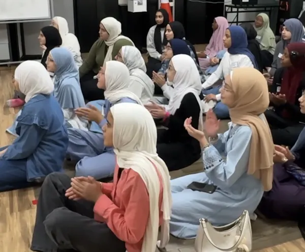 Muslim sisters clapping