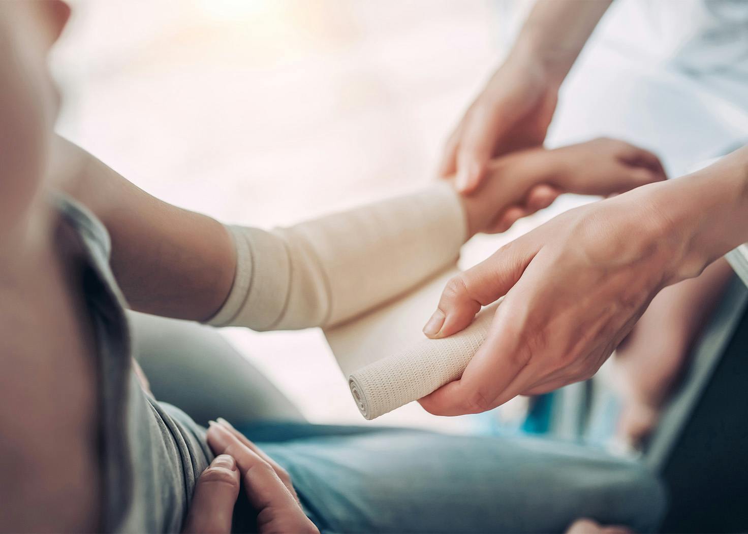 Person's arm being bandaged
