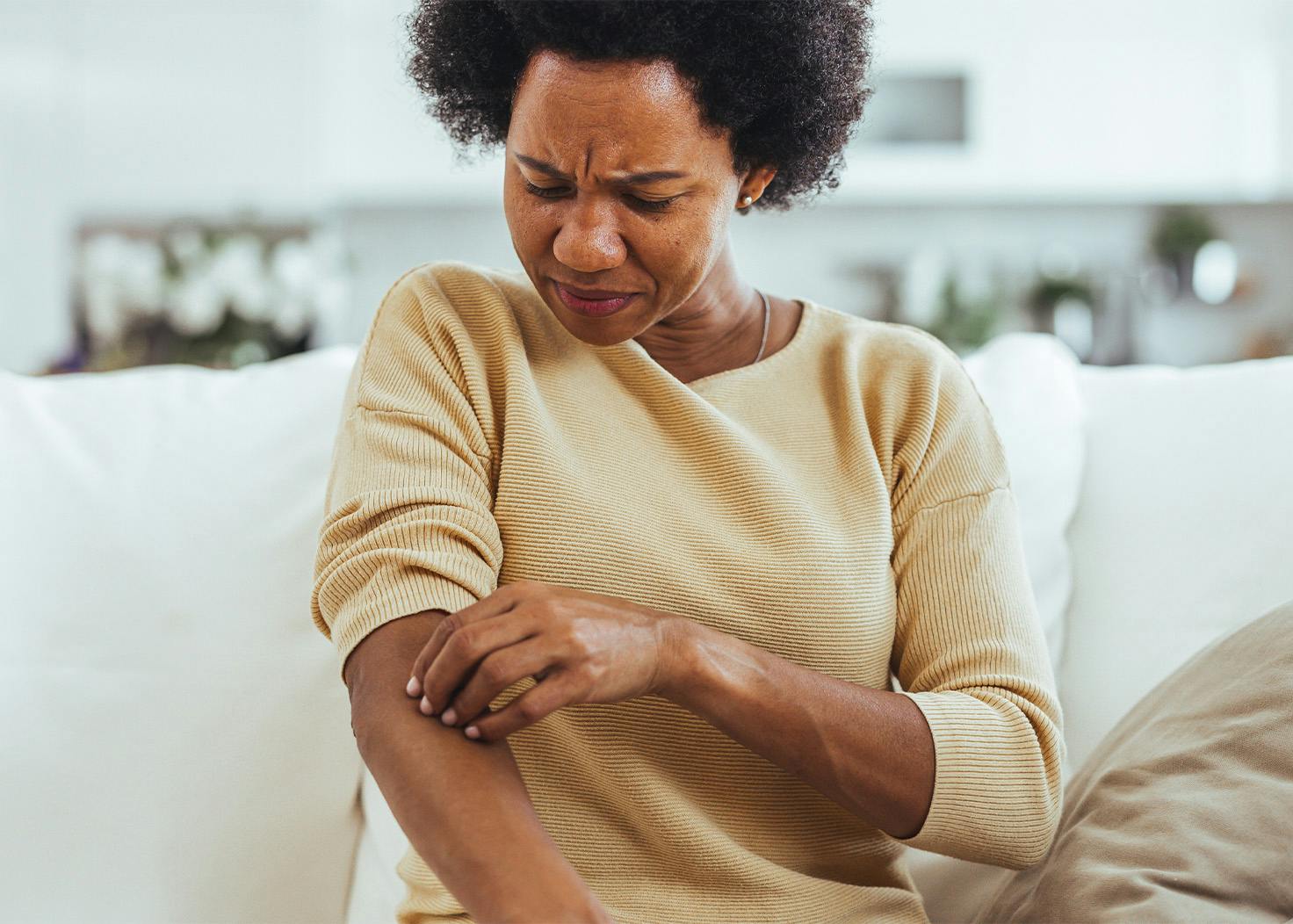Woman scratching her arm