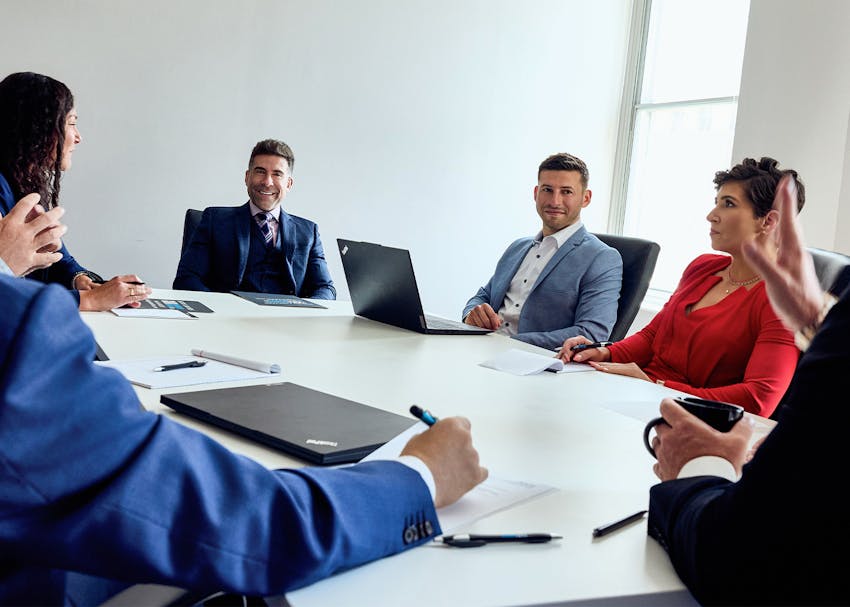 Kwartler Manus lawyers sitting at a table together