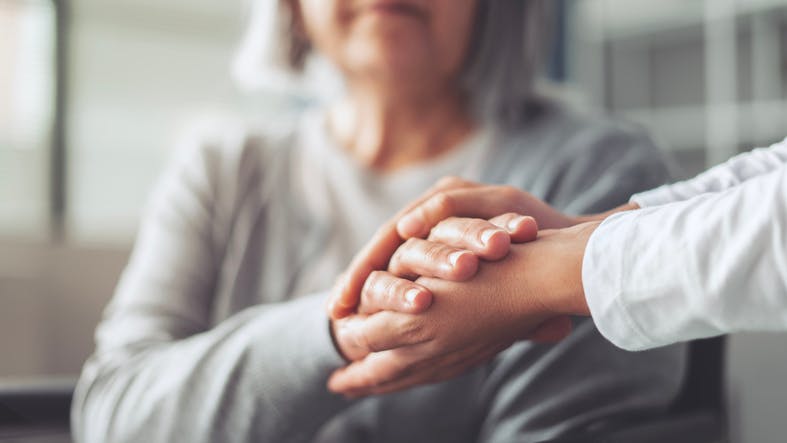 Women holding hands with each other