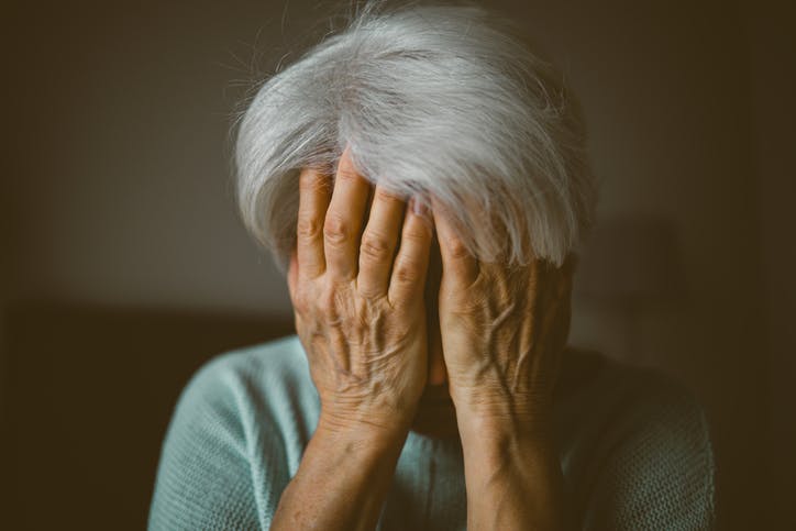 A woman holding her face in her hands