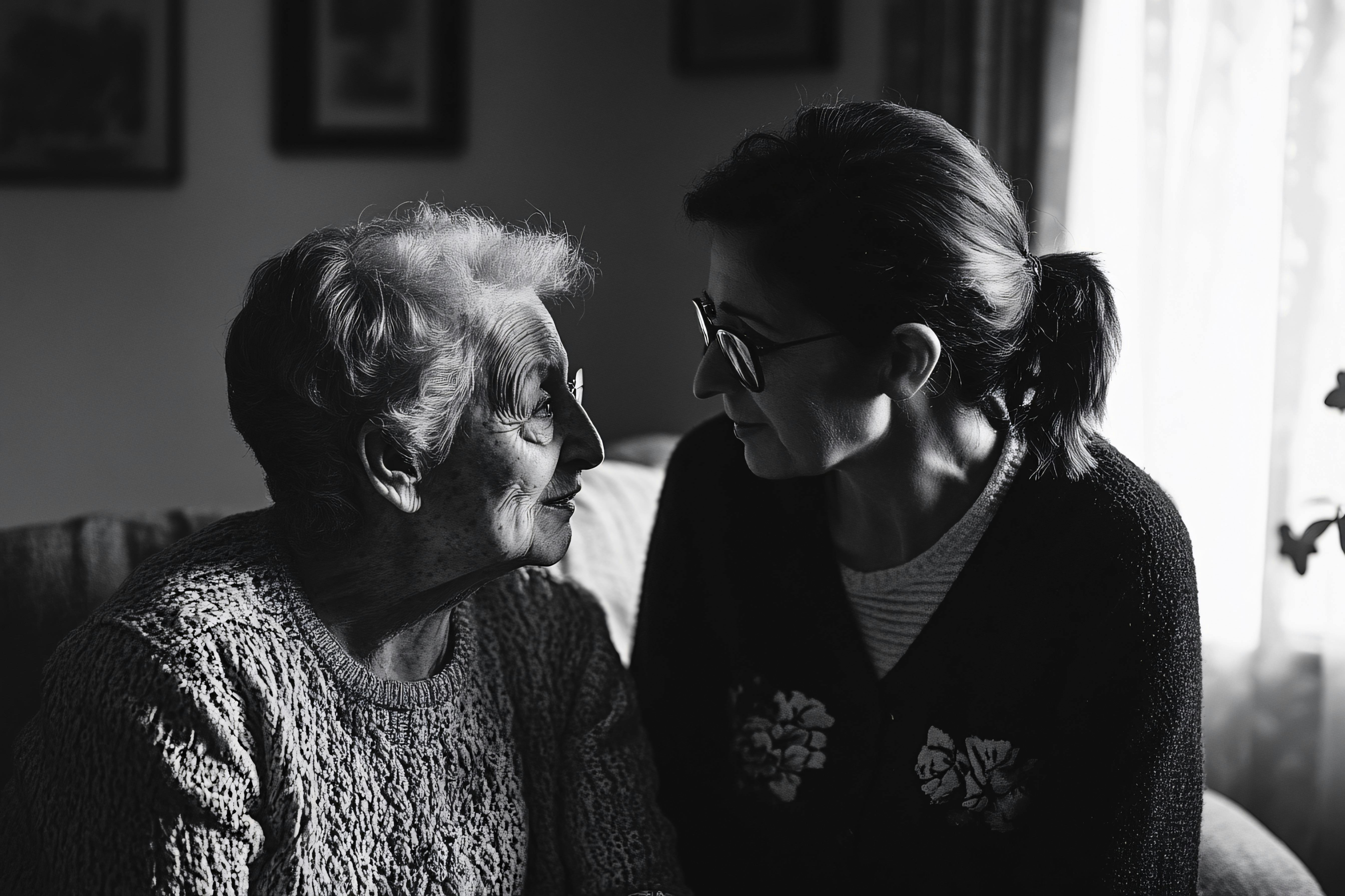 An older woman and her daughter looking at each other