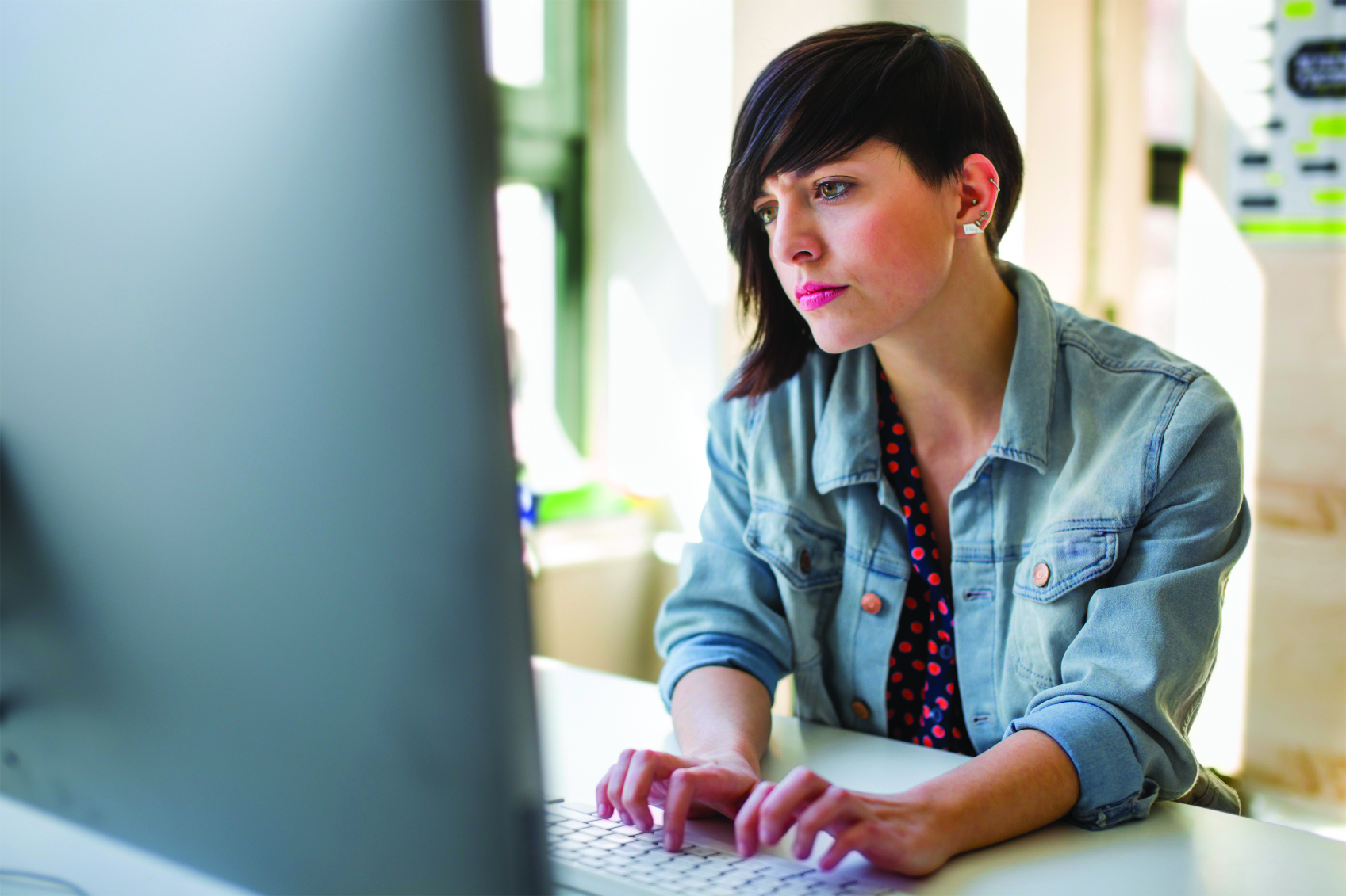 Woman working on desktop computer