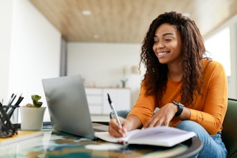 Smiling woman sitting at desk working