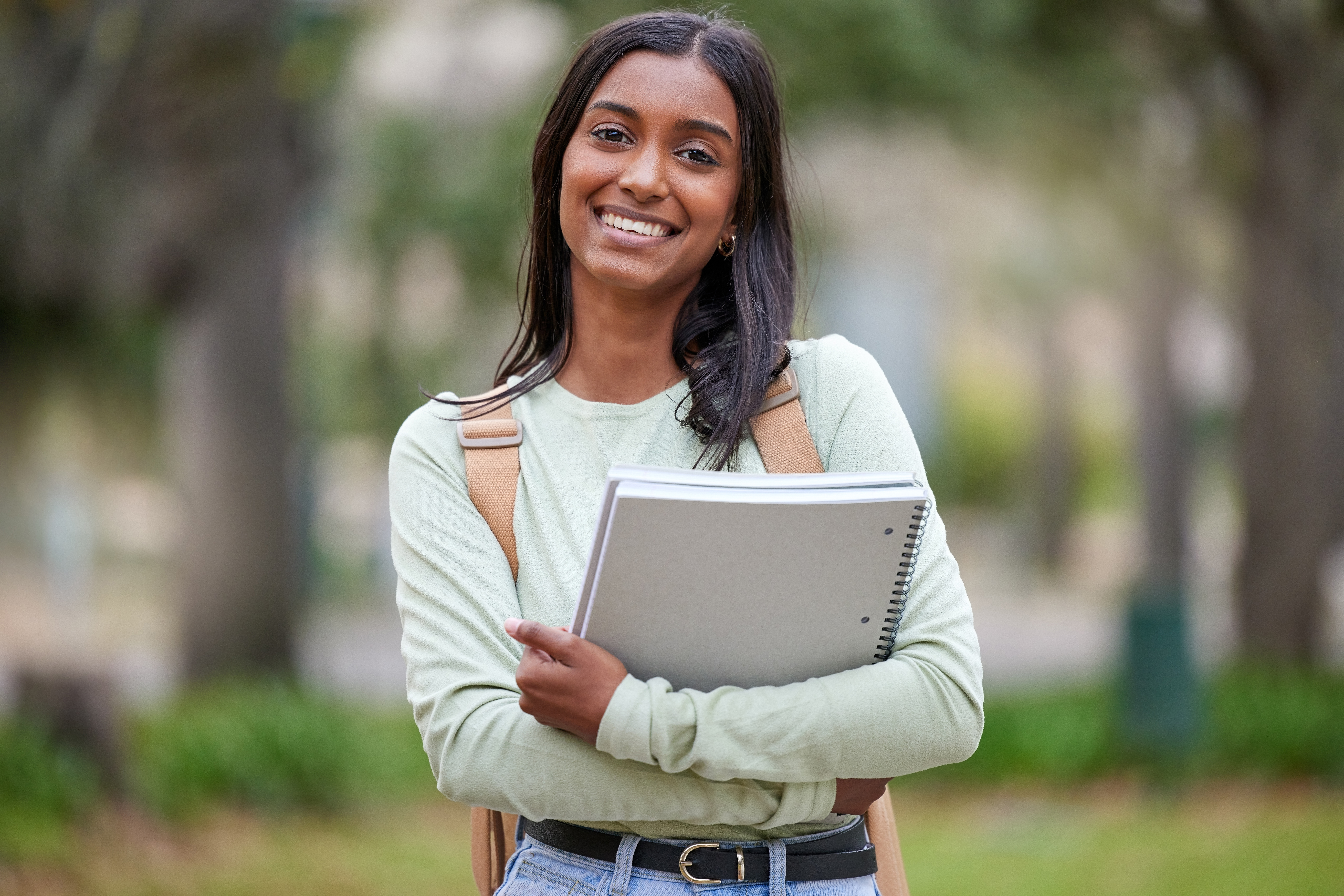 Young woman carrying her college books