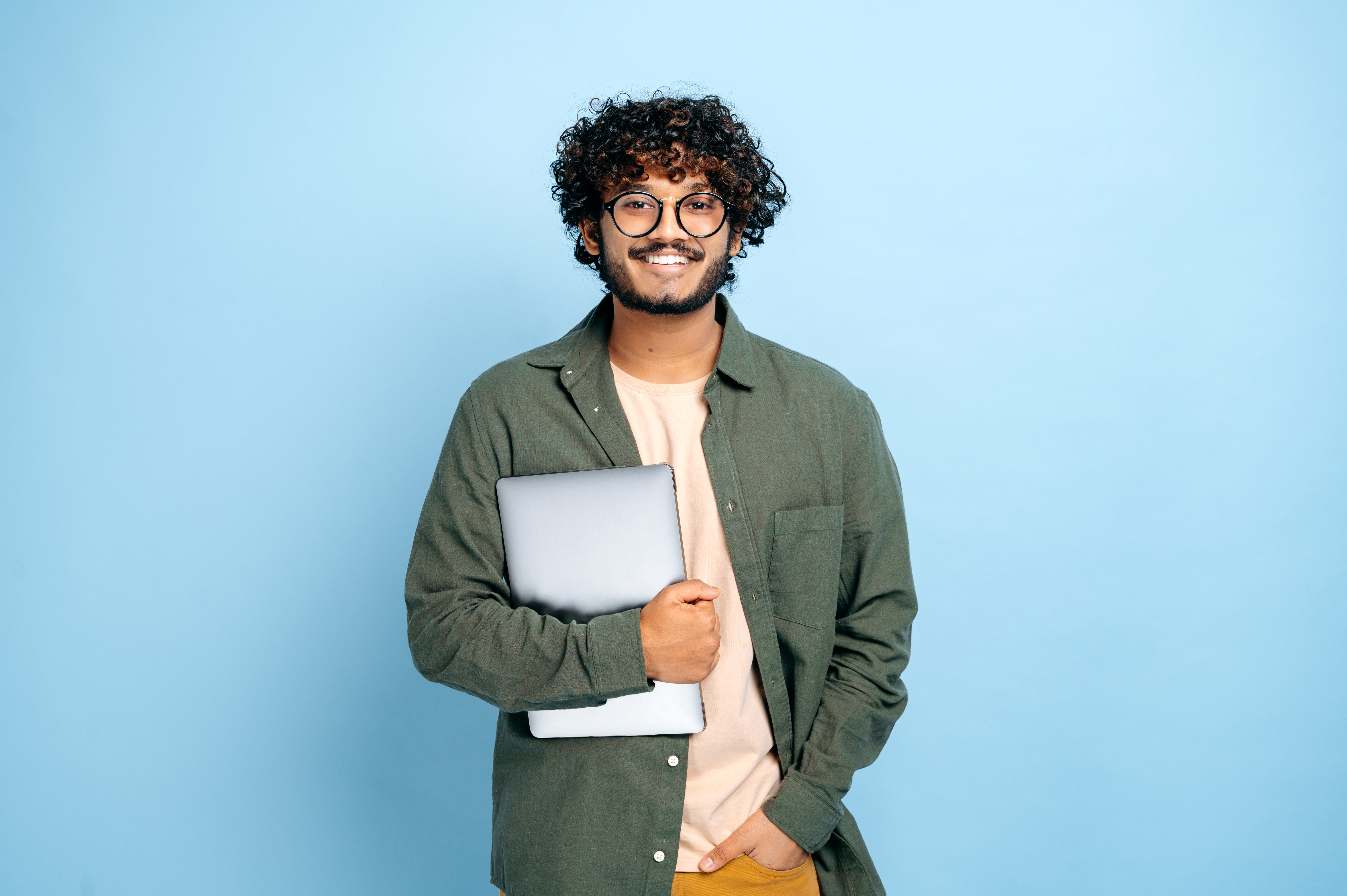 Student holding a laptop in hand