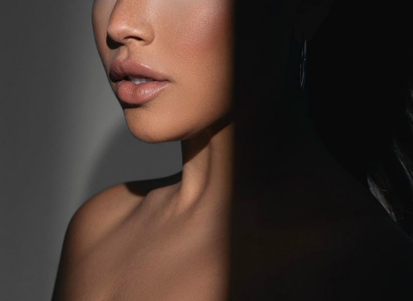 close up of womans face from the nose to bust