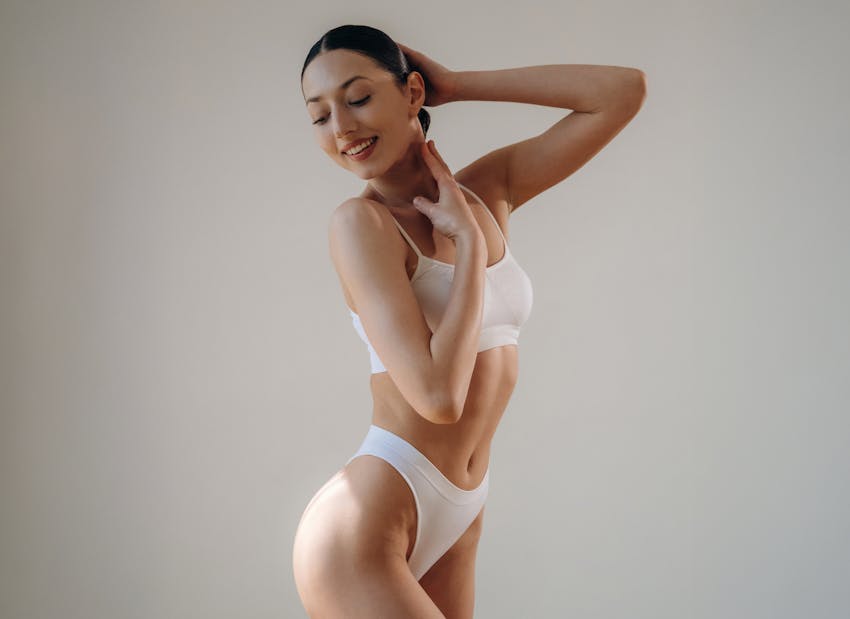 woman in bikini touching head