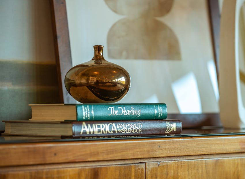vase and books on a dresser