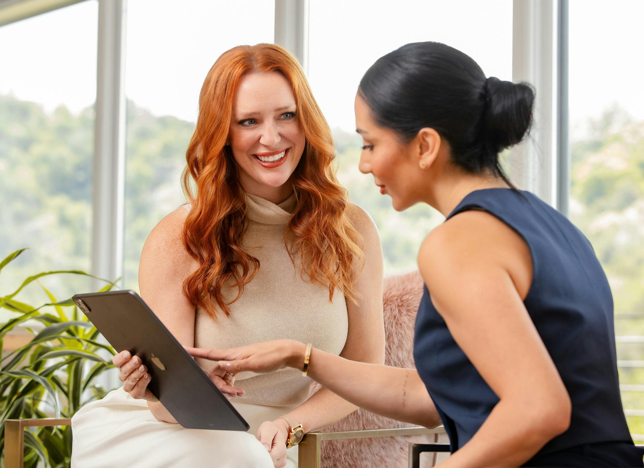Kristina Kashyap with patient holding an IPad