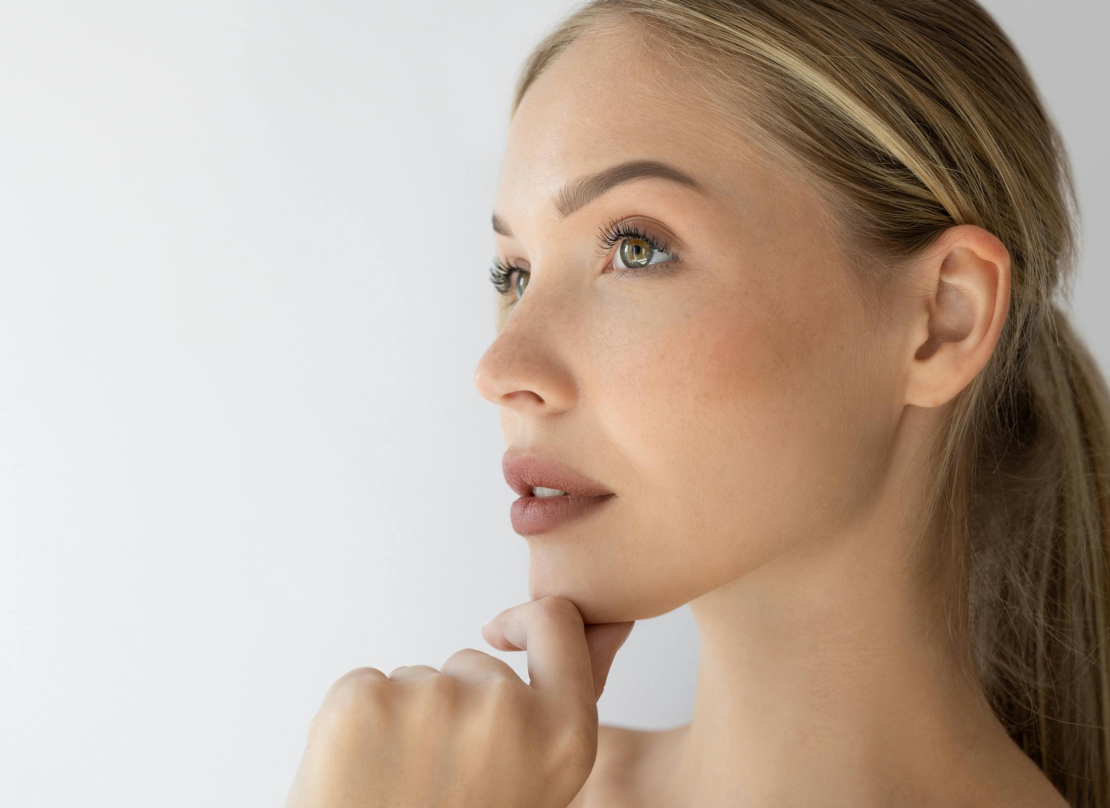 womans side profile touching her chin
