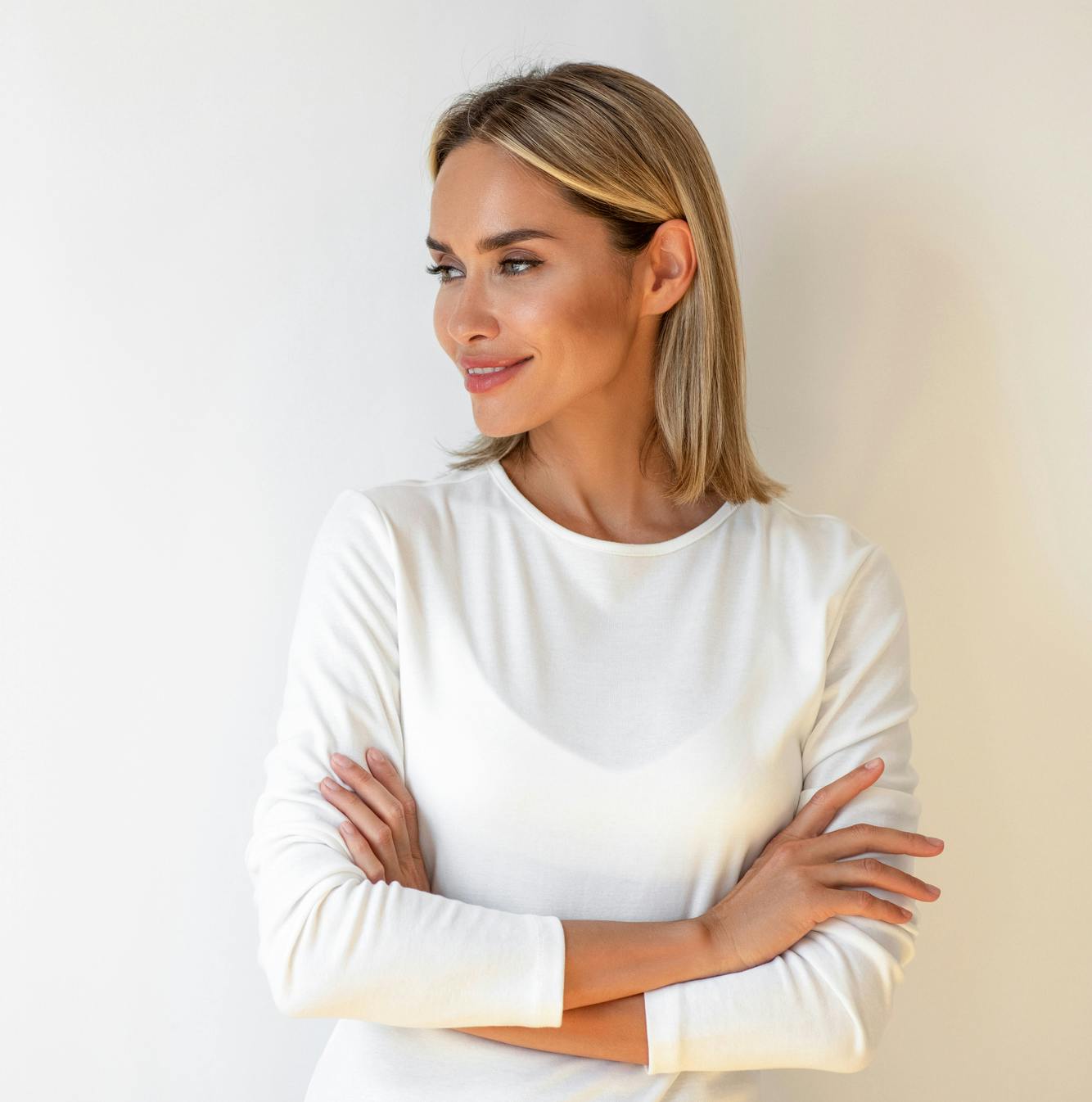 woman with arms crossed looking to the side