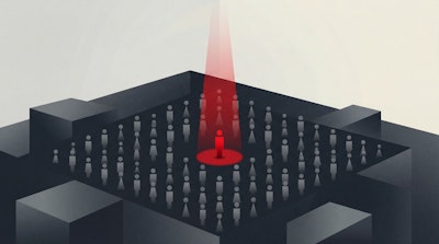 Figure targeted by red surveillance beam in a dark maze