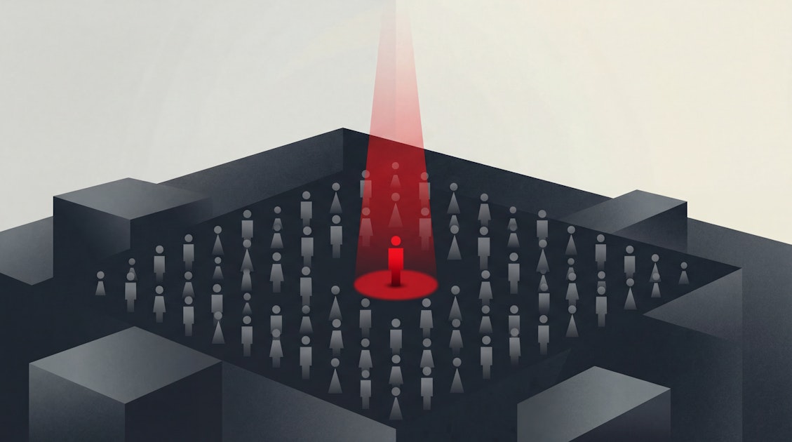 Figure targeted by red surveillance beam in a dark maze