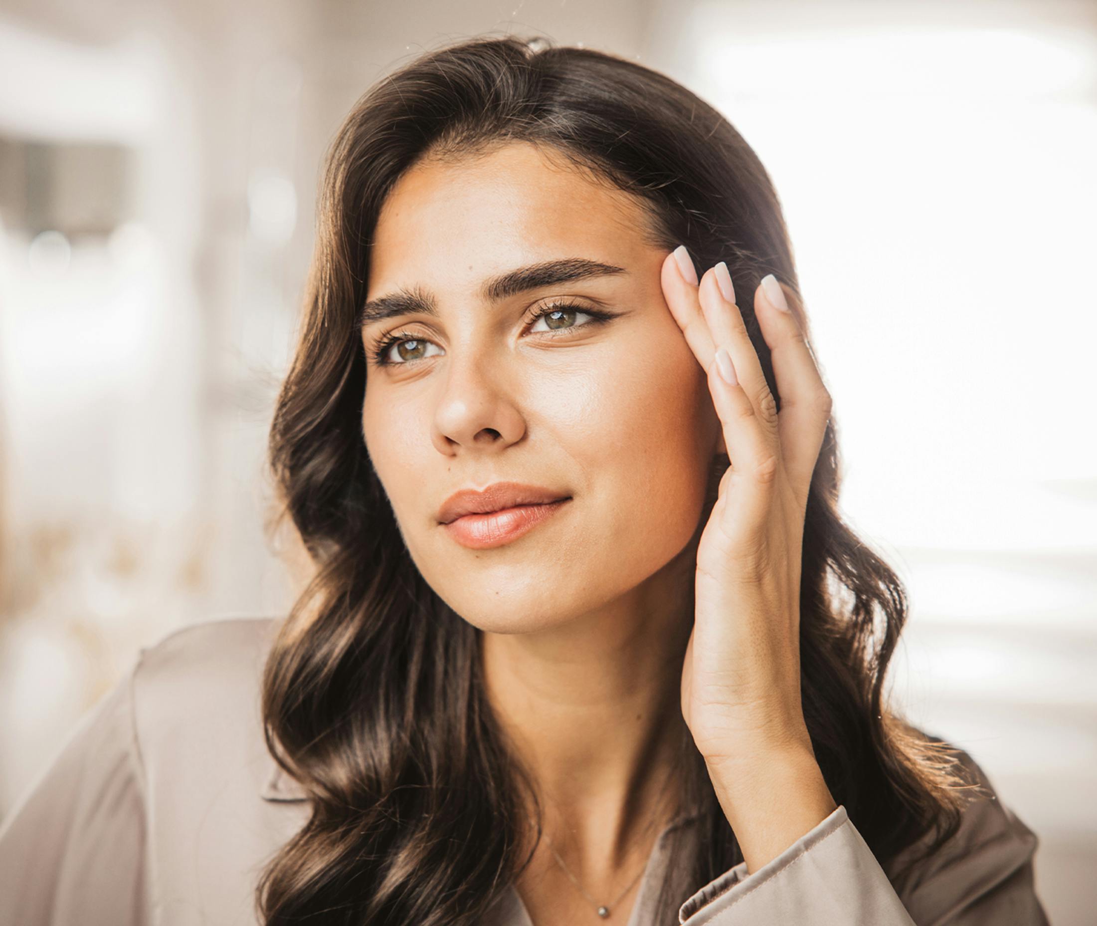 long haired woman pulling skin aorund her eye