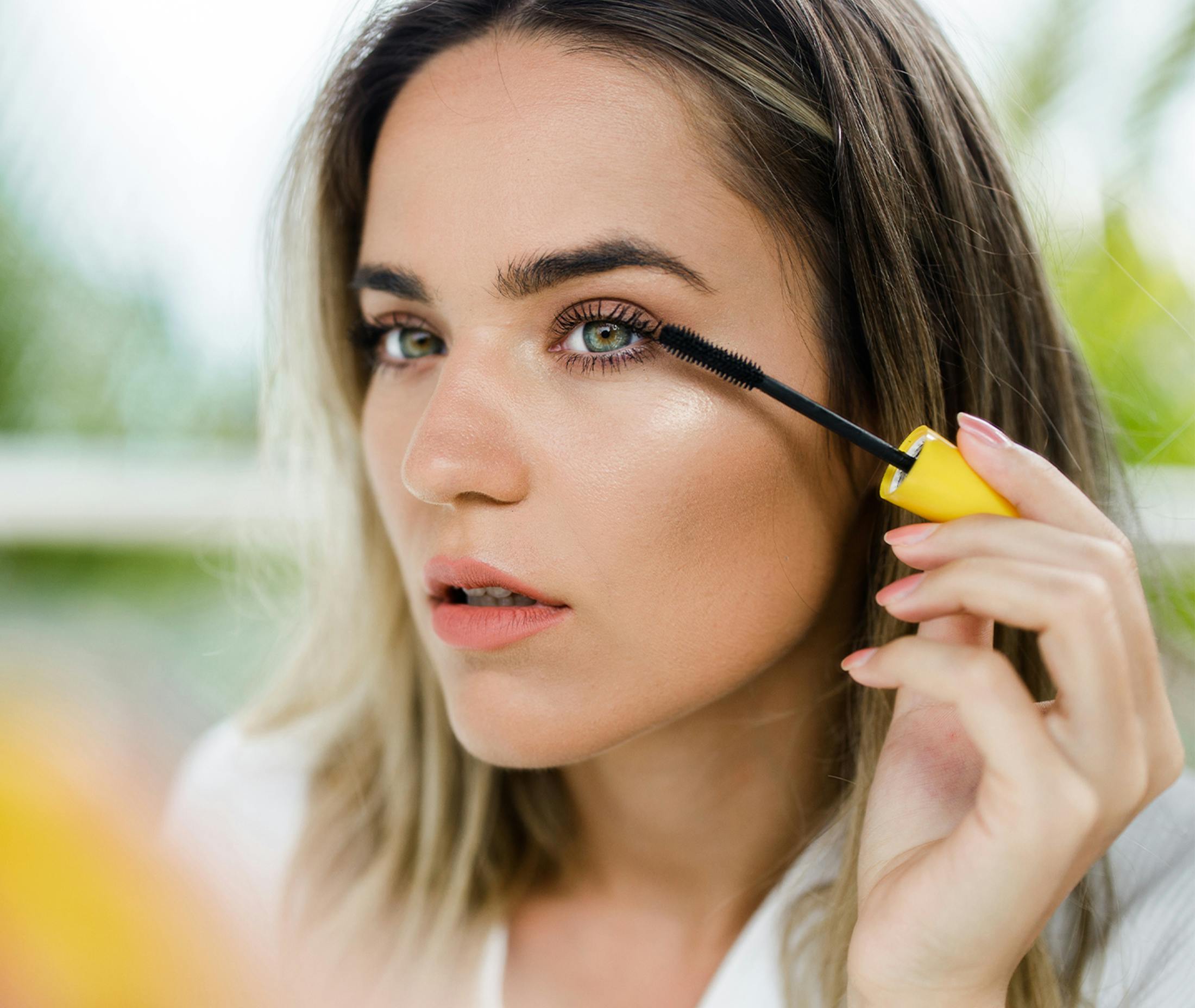 woman applying mascara