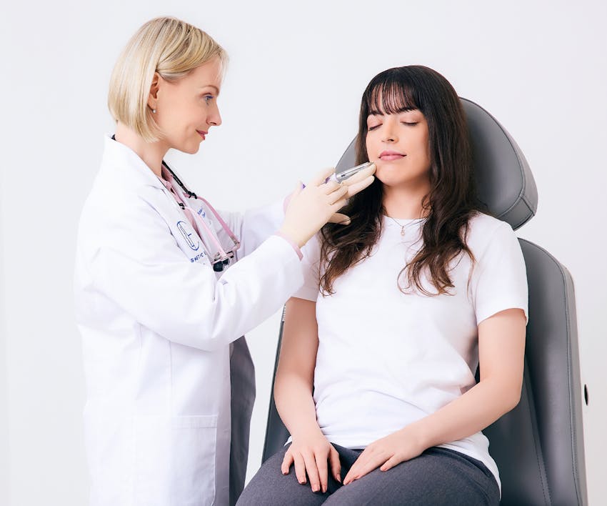 Dr. Ginter injecting filler into female patient