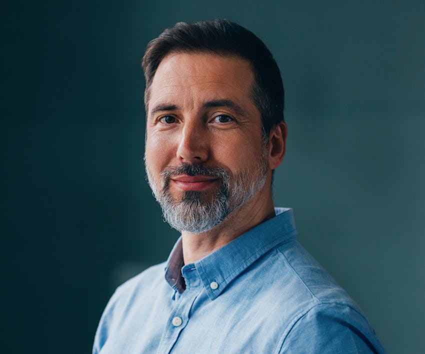 smiling man in blue shirt