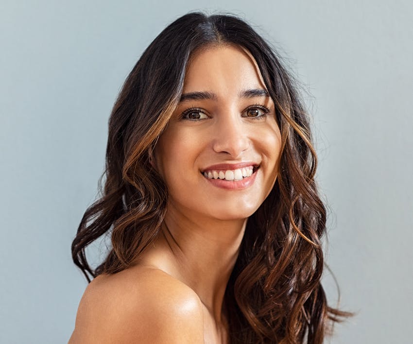 smiling woman with long curly hair