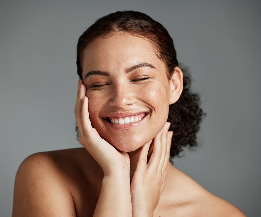 smiling woman touching her face