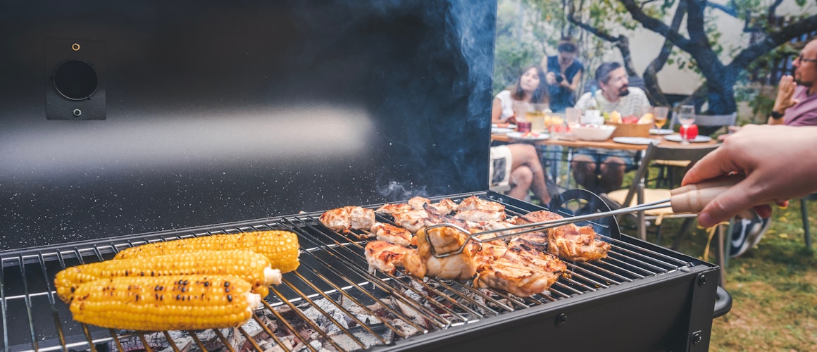 Barbecue with party in background