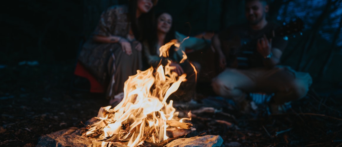 People sat round a campfire