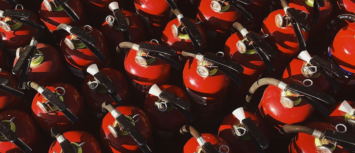 red and black ceramic mugs on black steel rack