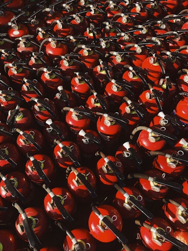 red and black ceramic mugs on black steel rack