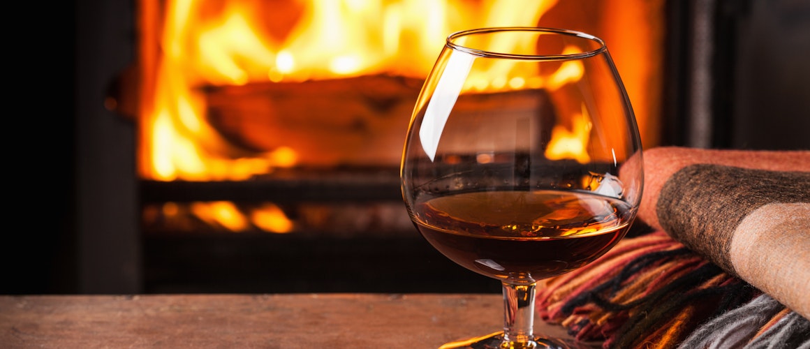 glass with fire in background