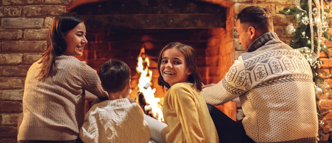 Family in front of fire