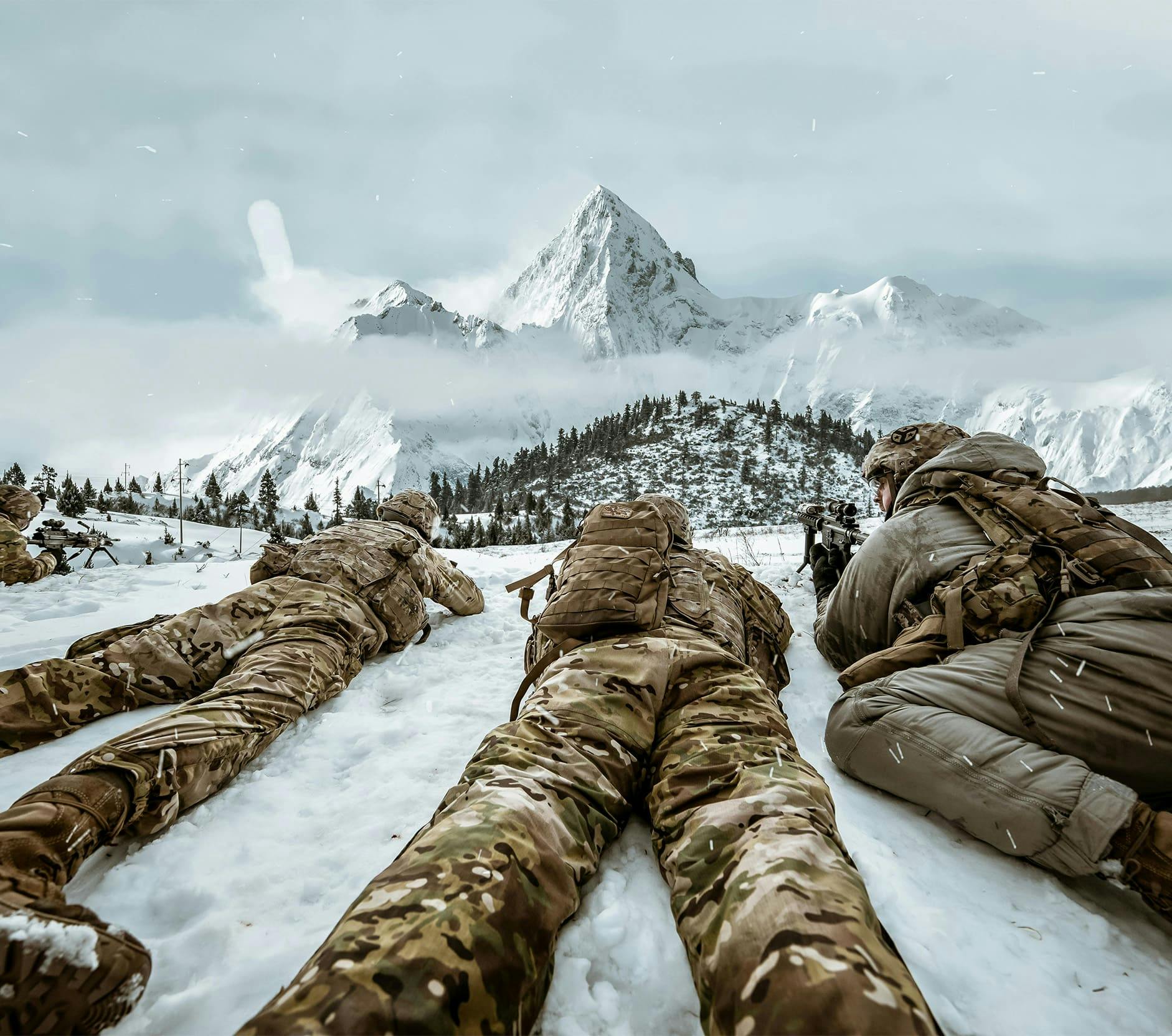 army people laying in the snow