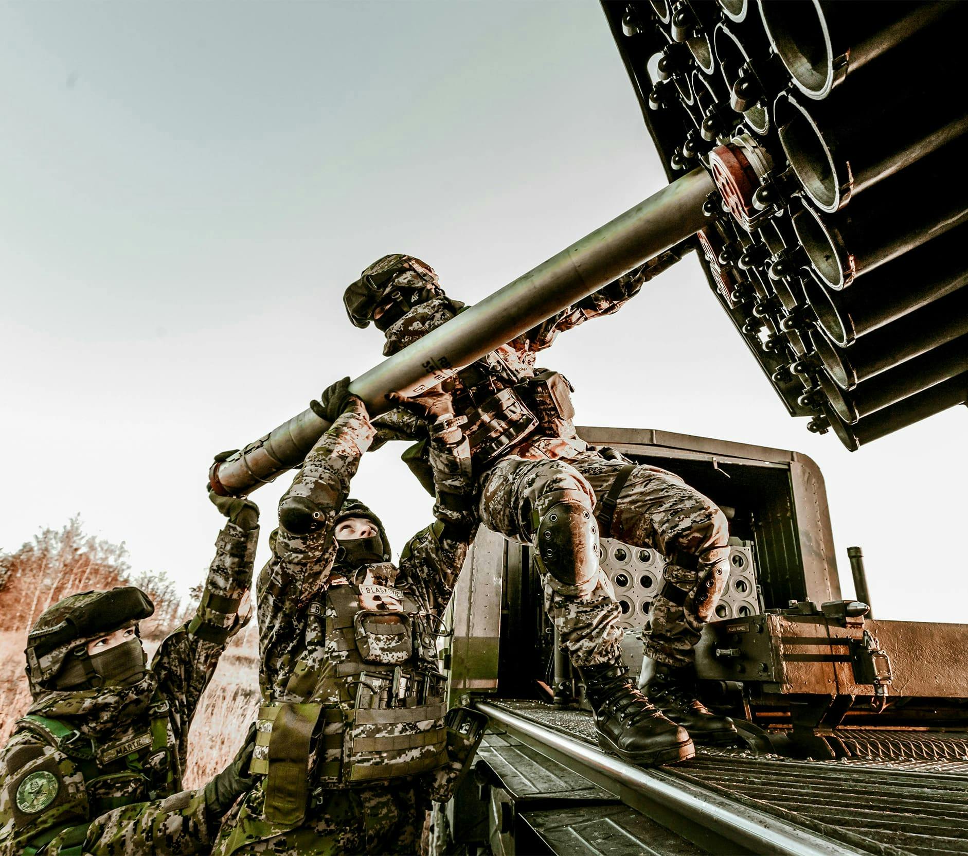 soldiers loading a missile launcher