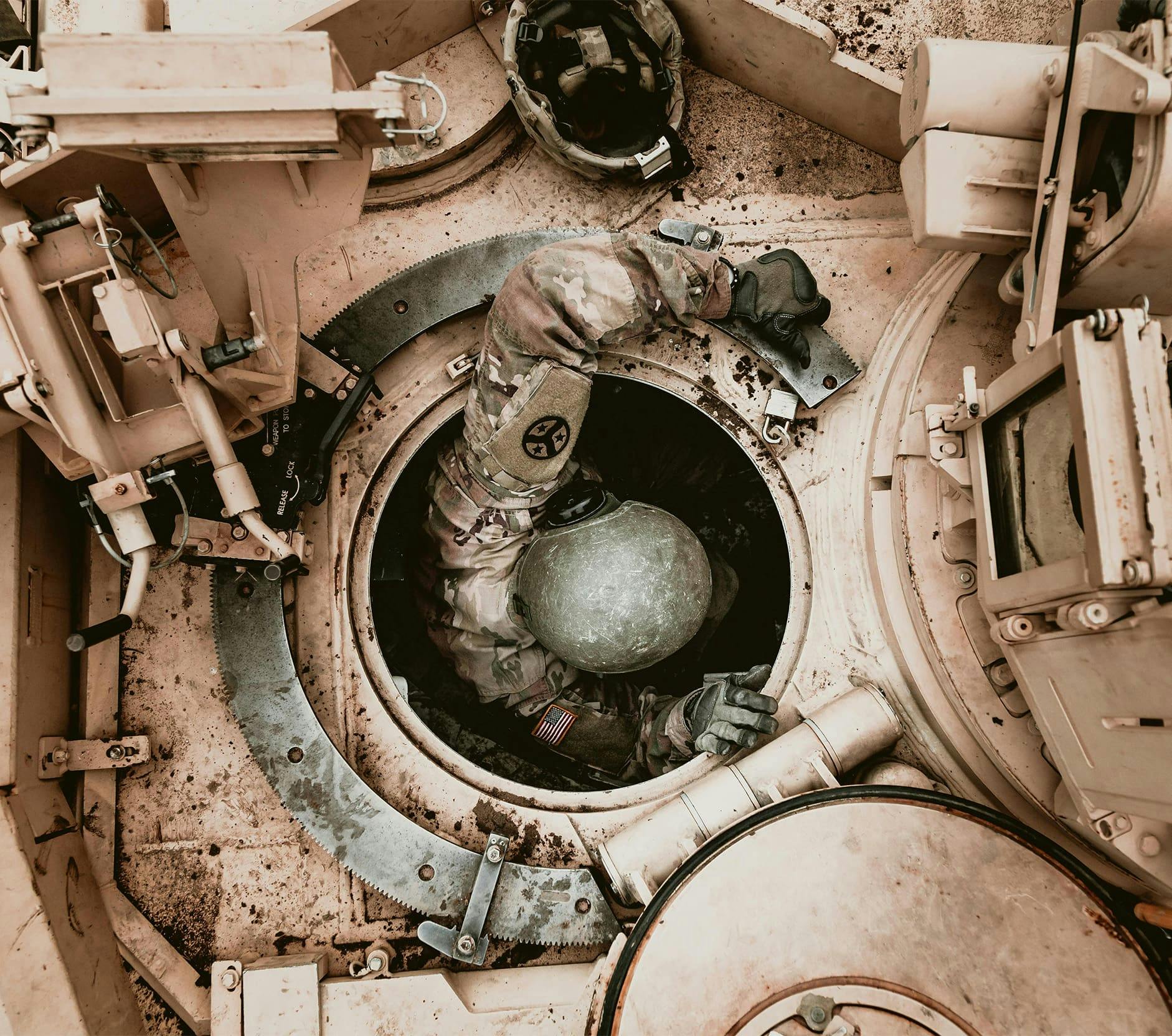 soldier climbing into a tank