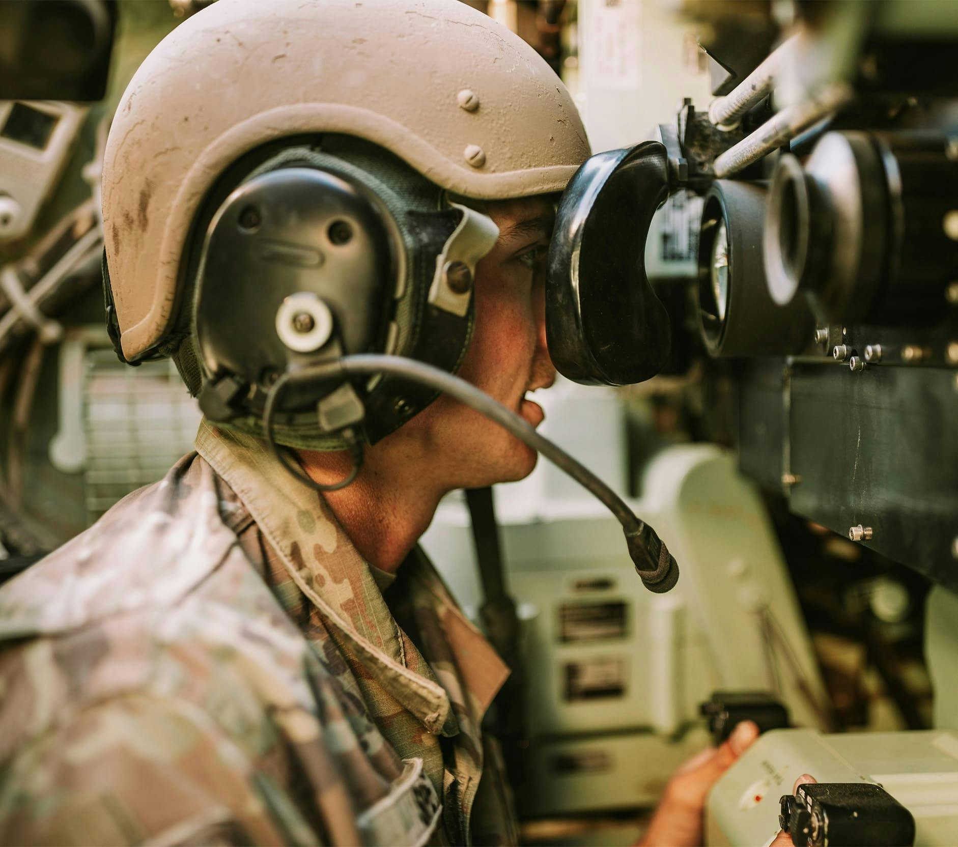 soldier looking through a telescope