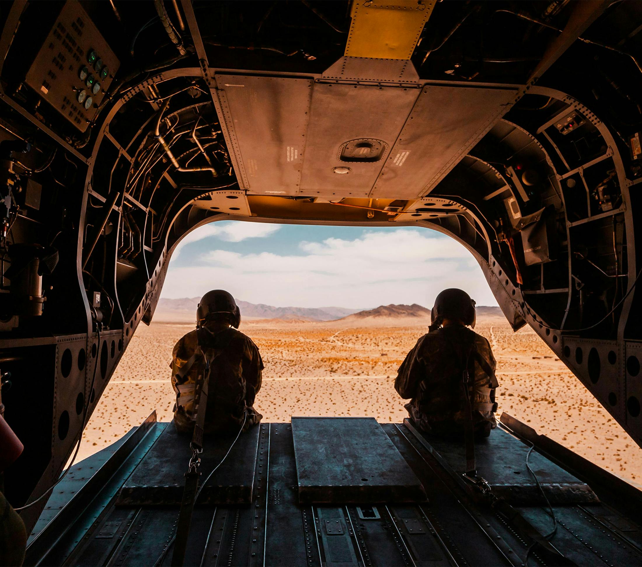 soldiers sitting off the edge of an airplane