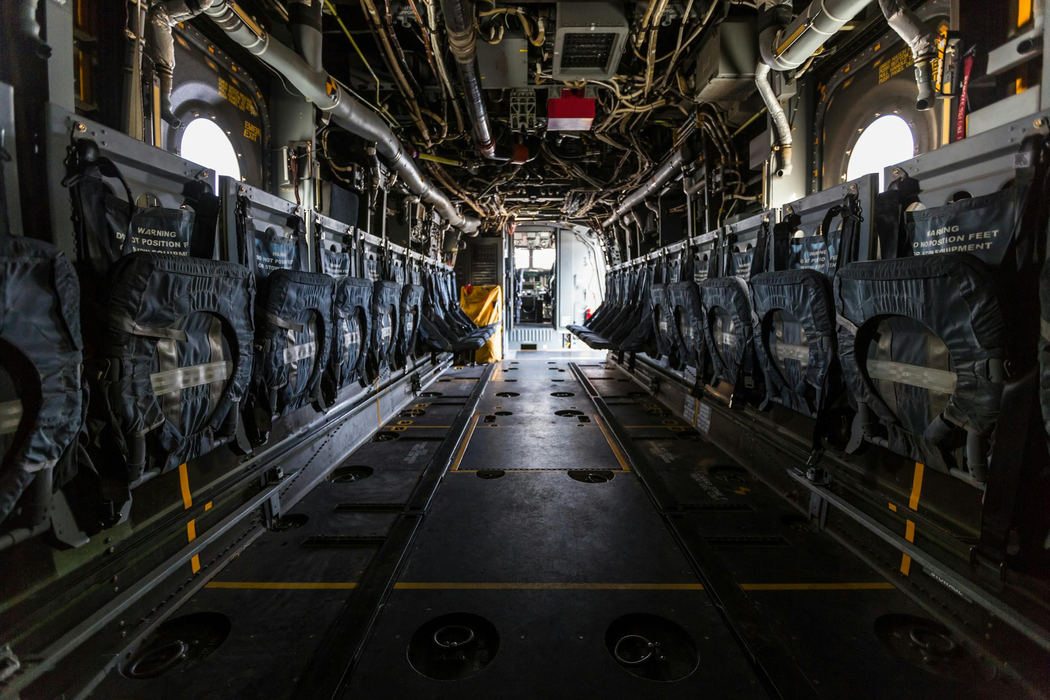 Interior of plane fuselage with seats and ground attachment points