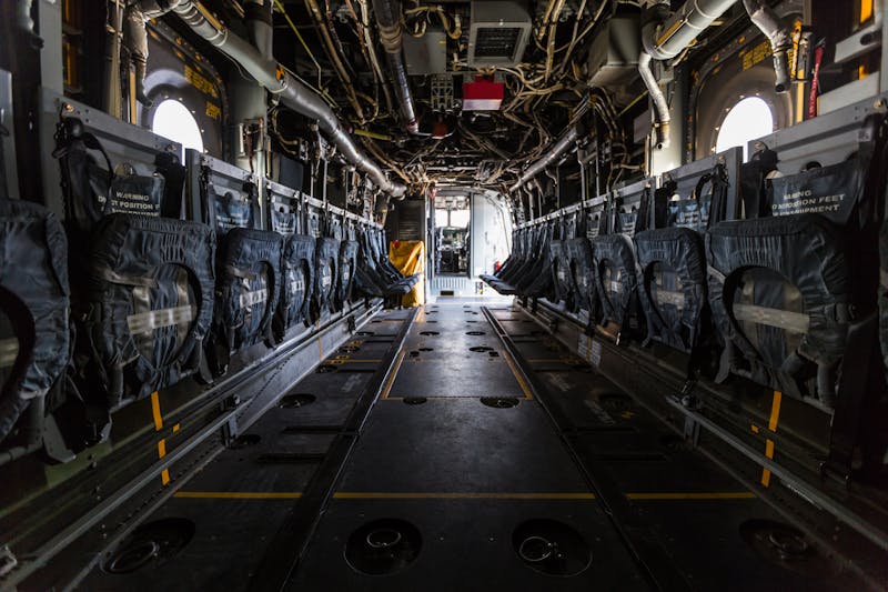 Interior of plane fuselage with seats and ground attachment points