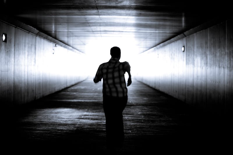 Man is running out of the tunnel into the light